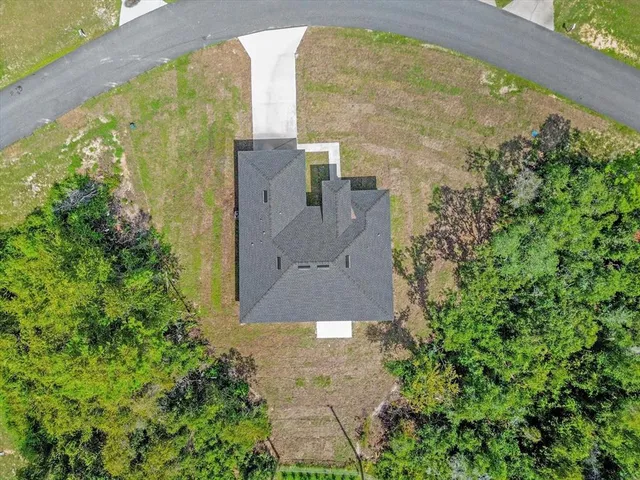 an aerial view of a house with a yard
