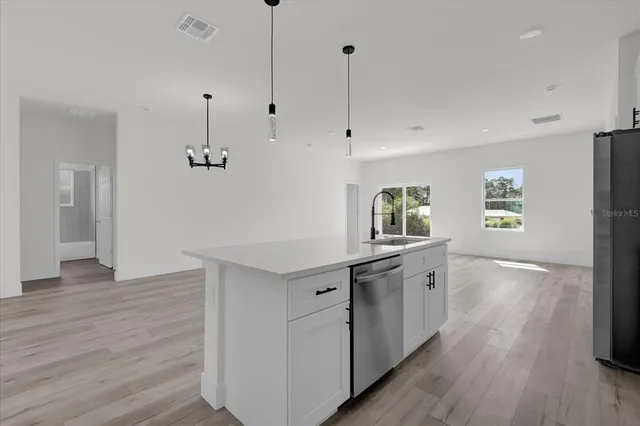 a kitchen with a wooden floor and window