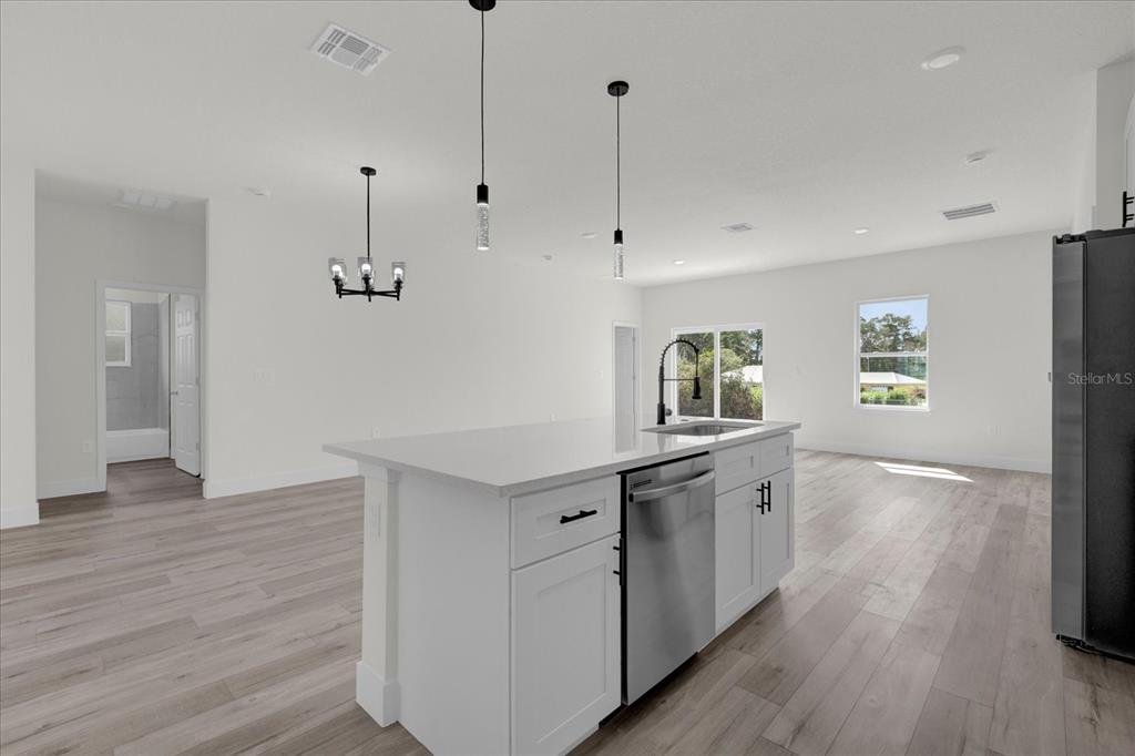 2396 Southwest 147th Lane Road Ocala, FL 34473 - Photo 7 of 32 a kitchen with a wooden floor and window