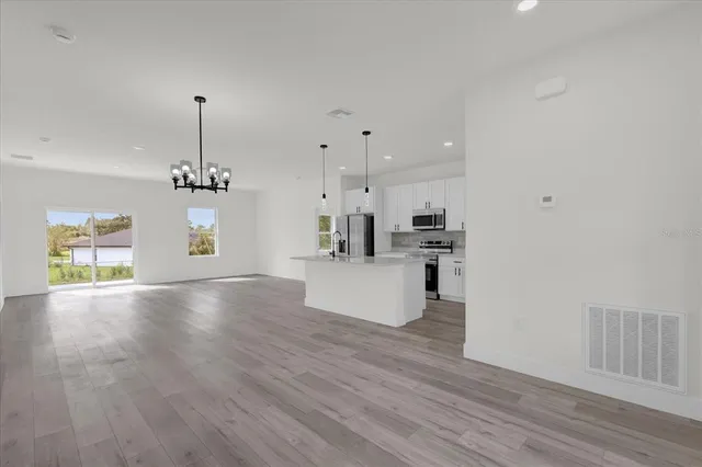 a view of a kitchen with a sink and a window