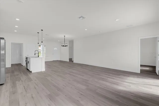 a view of a kitchen with a sink and a refrigerator