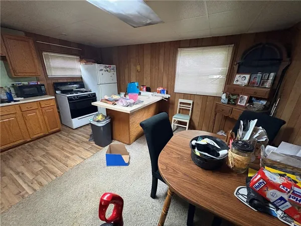 a view of kitchen with furniture and clutter