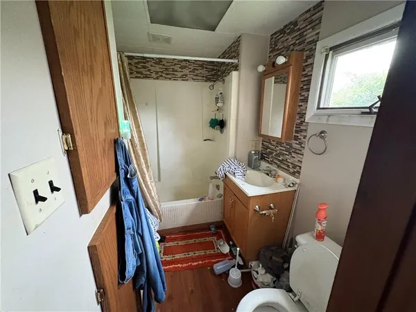 a bathroom with toilet sink and mirror