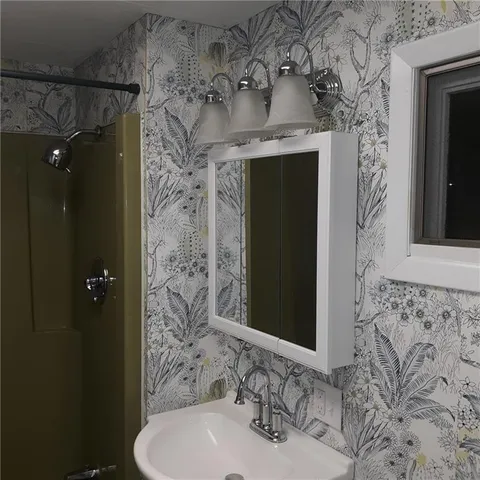 a bathroom with a sink and a mirror