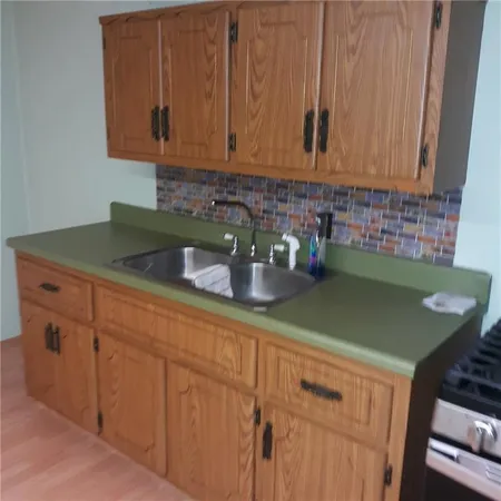 a kitchen with stainless steel appliances granite countertop a sink a stove and cabinets