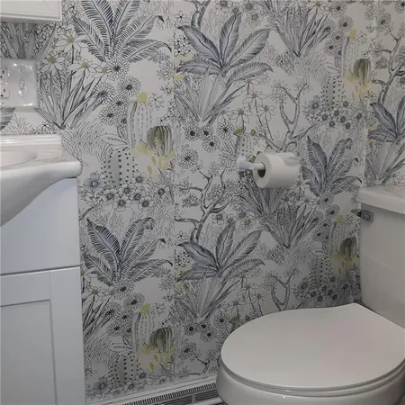 a white toilet sitting next to a shower curtain