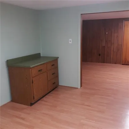 an empty room with wooden floor