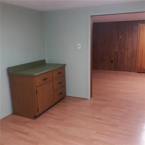 an empty room with wooden floor