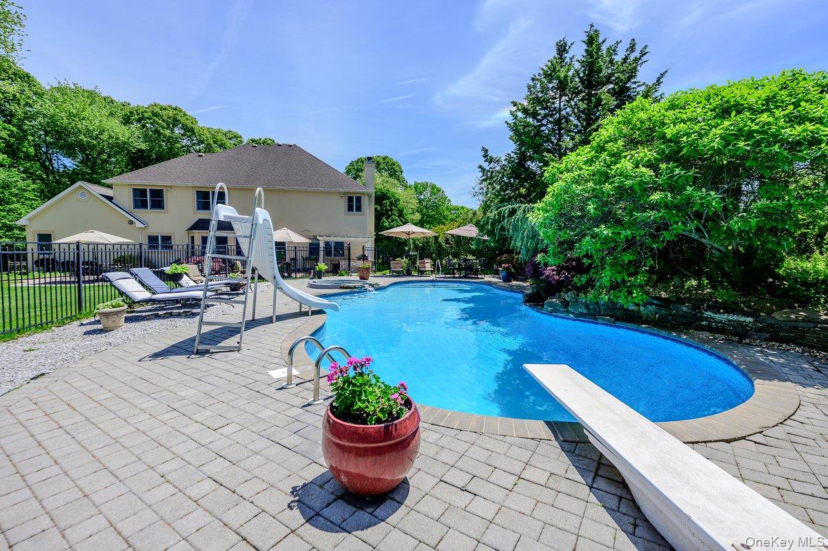 129 Round Swamp Road Huntington, NY 11743 - Photo 45 of 49 Kidney-shaped swimming pool featuring a diving board and integrated slide