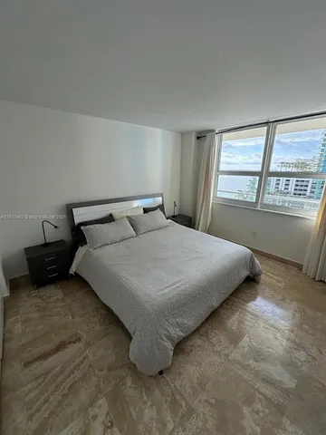 a bedroom with a bed and window