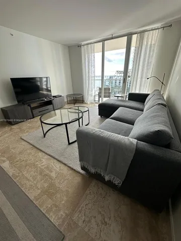 a living room with furniture and a large window