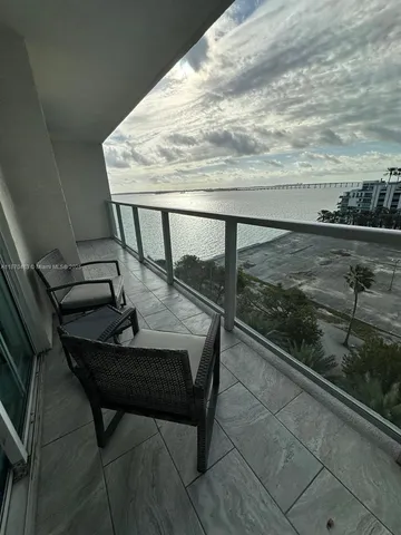 a view of a balcony with furniture