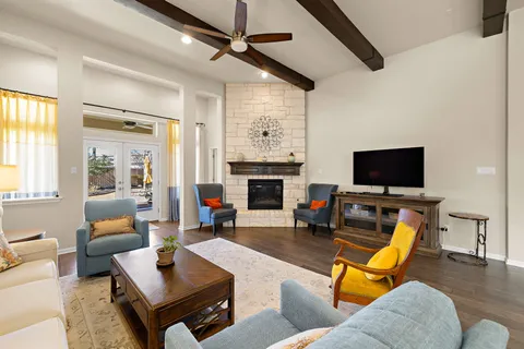 a living room with furniture a flat screen tv and a fireplace