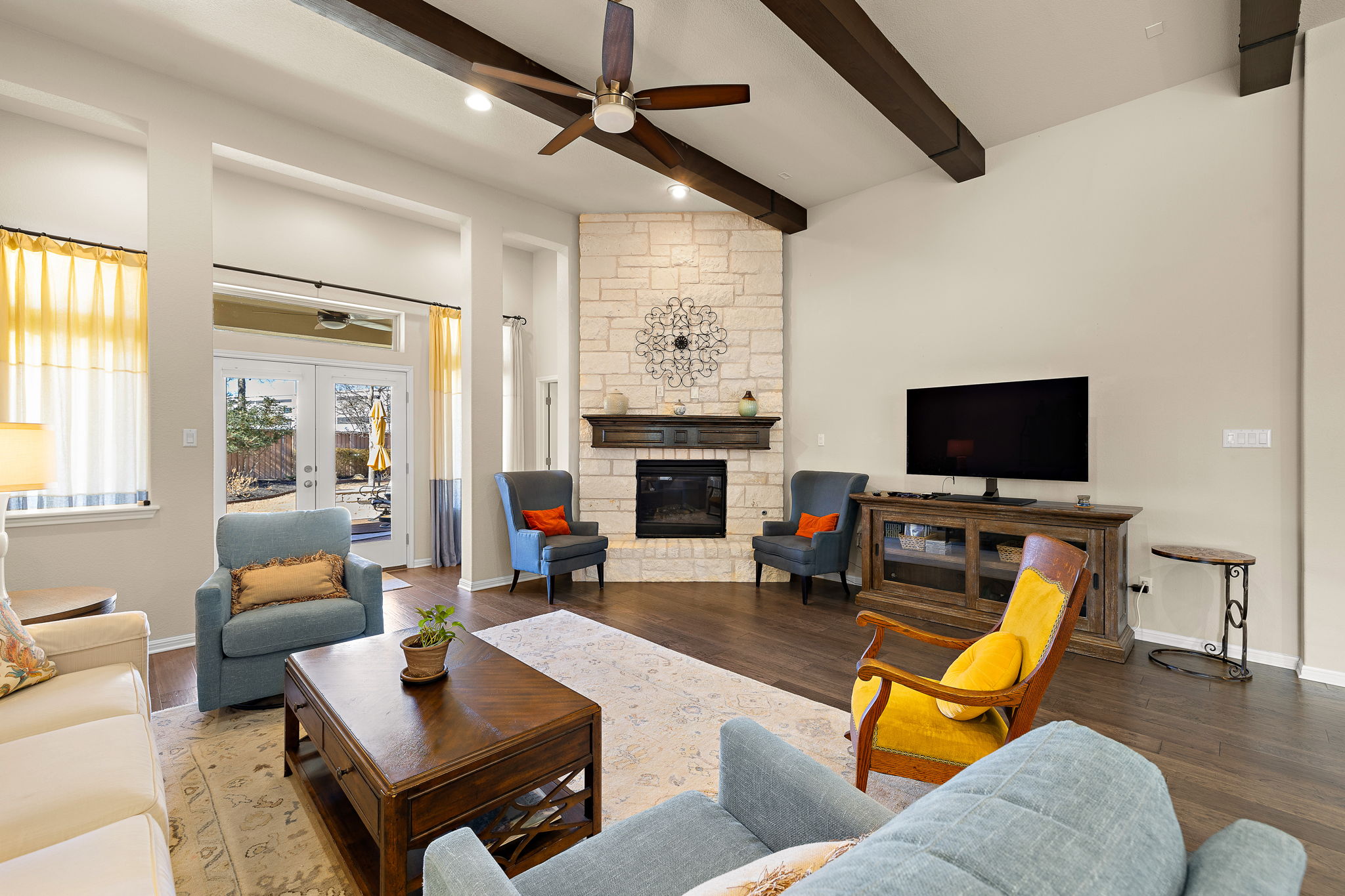 5016 Yucca Flower Lane Georgetown, TX 78626 - Photo 10 of 31 a living room with furniture a flat screen tv and a fireplace