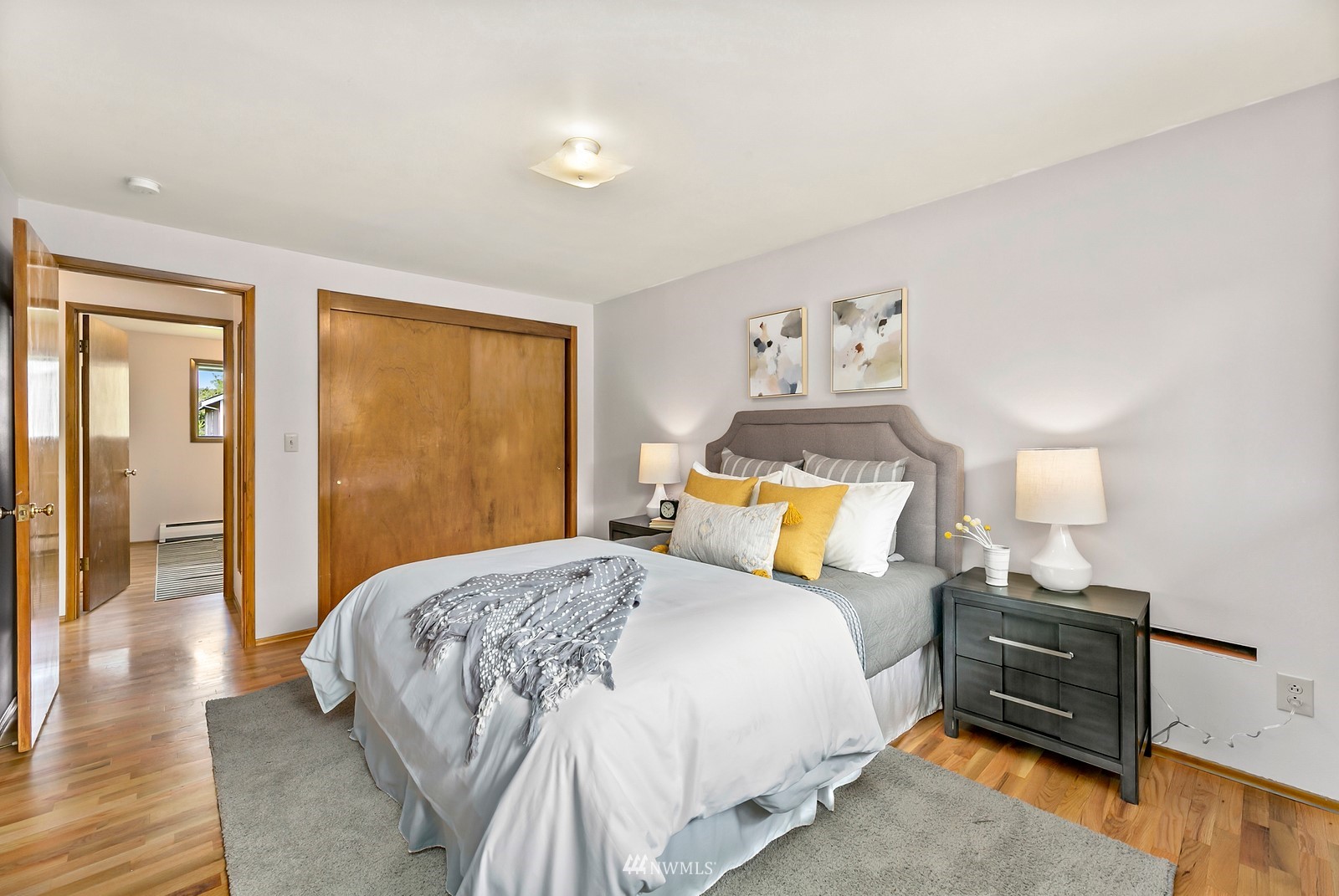 309 Powell Avenue Southwest Renton, WA 98057 - Photo 11 of 29 a bedroom with a bed and wooden floor