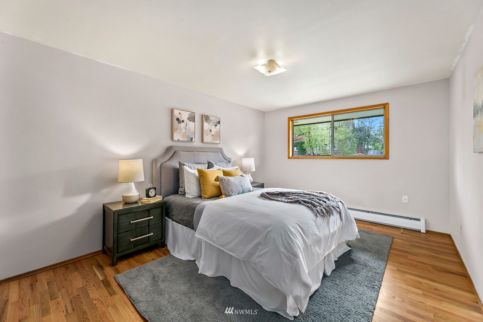 309 Powell Avenue Southwest Renton, WA 98057 - Photo 12 of 29 a bedroom with a bed and wooden floor