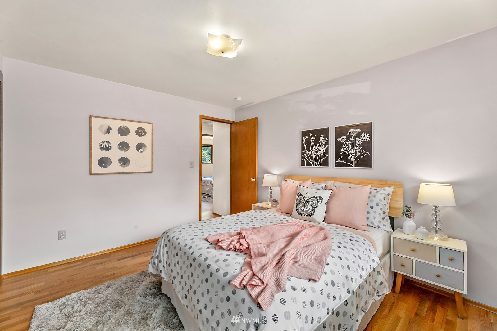 309 Powell Avenue Southwest Renton, WA 98057 - Photo 13 of 29 a bedroom with a large bed and a chandelier