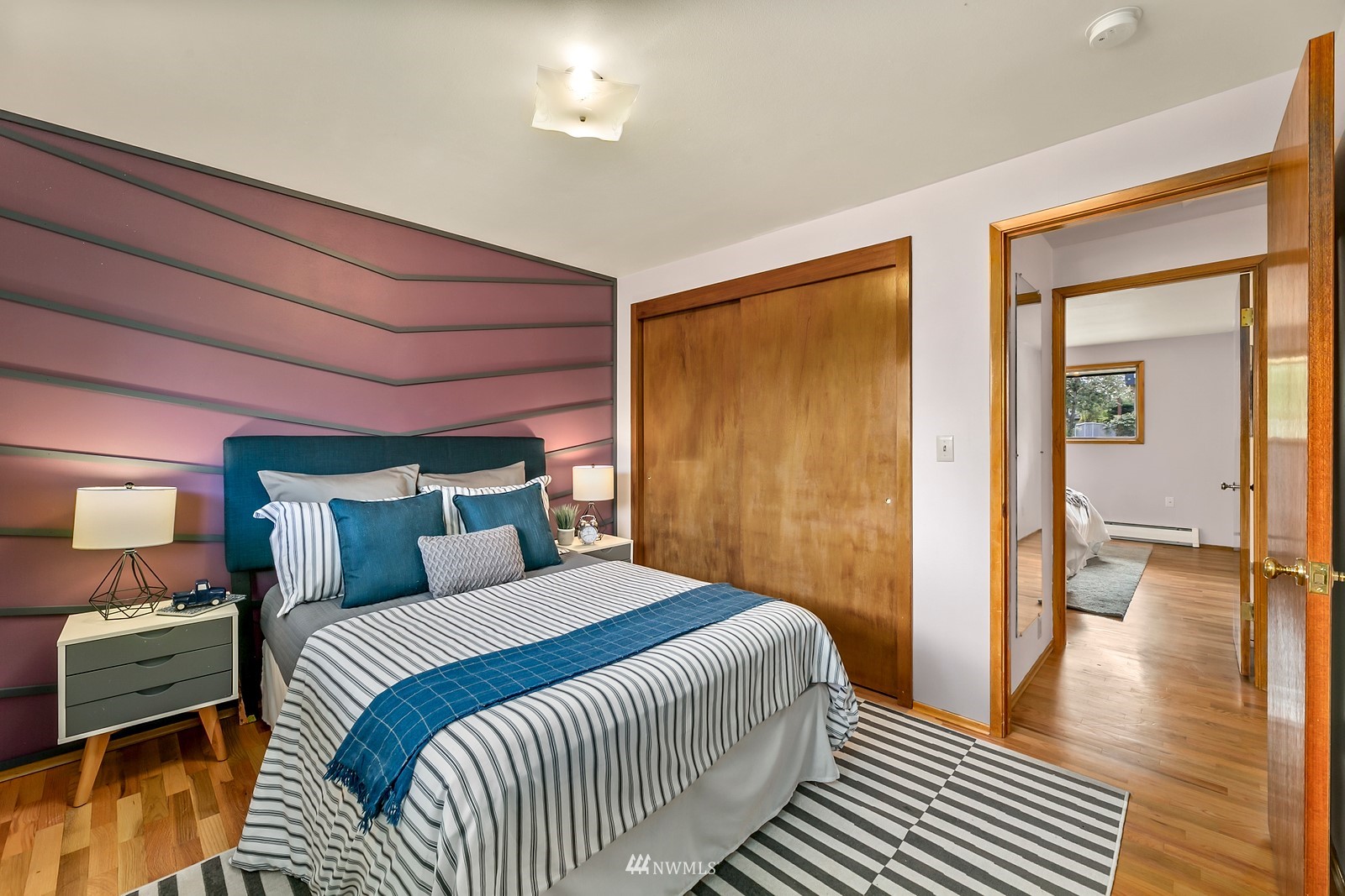 309 Powell Avenue Southwest Renton, WA 98057 - Photo 15 of 29 a bedroom with a bed and wooden floor