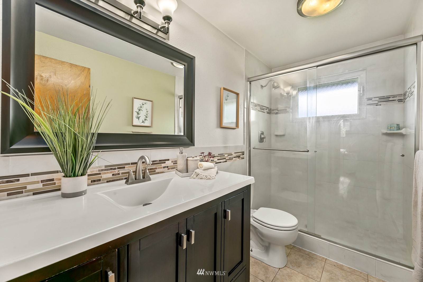 309 Powell Avenue Southwest Renton, WA 98057 - Photo 17 of 29 a bathroom with a sink a toilet and shower