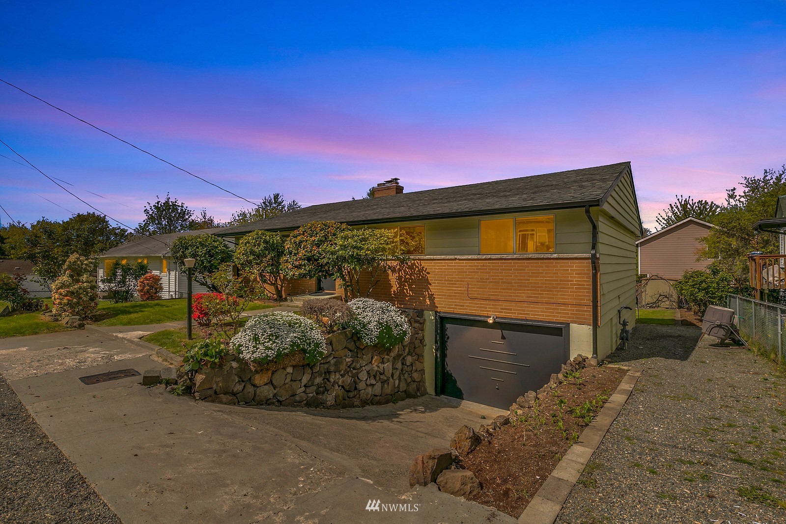 309 Powell Avenue Southwest Renton, WA 98057 - Photo 2 of 29 a front view of a house with a yard