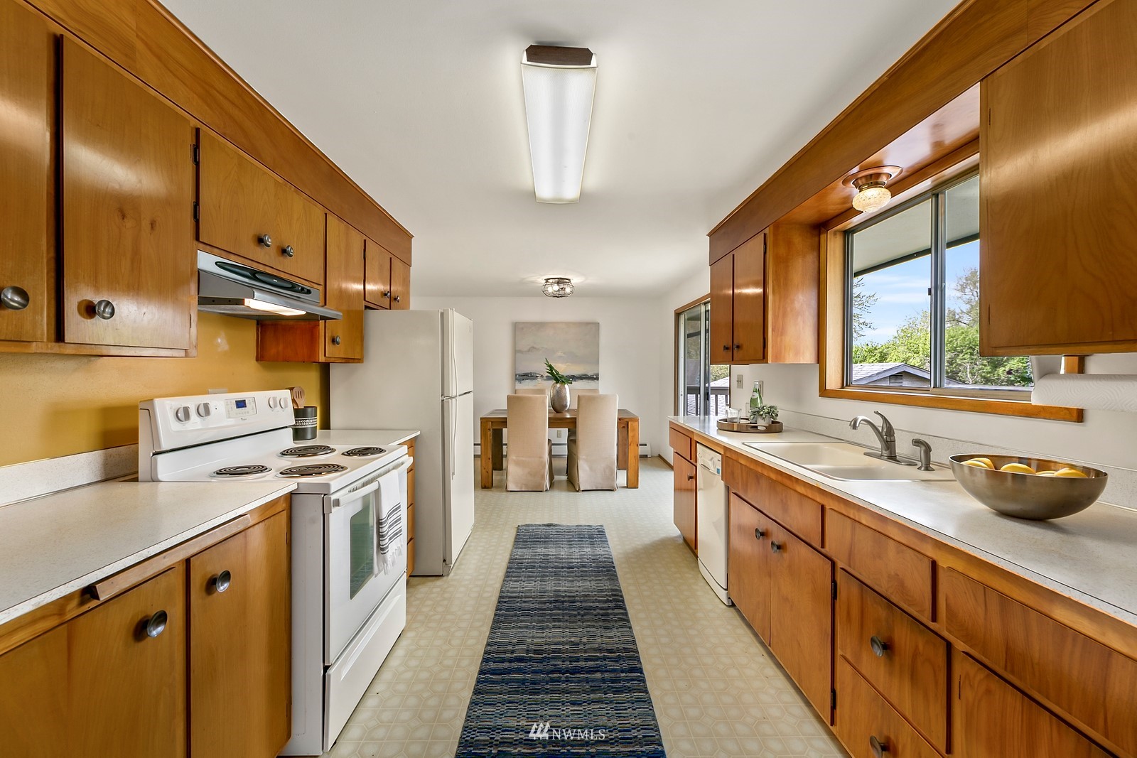 309 Powell Avenue Southwest Renton, WA 98057 - Photo 7 of 29 a kitchen with stainless steel appliances a sink stove and cabinets