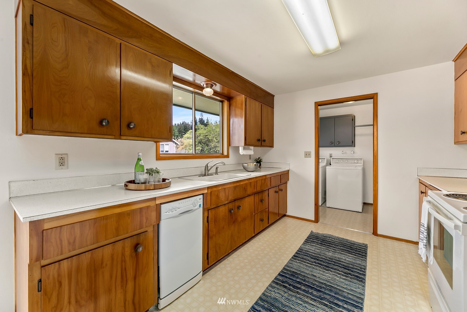309 Powell Avenue Southwest Renton, WA 98057 - Photo 8 of 29 a kitchen with a sink cabinets and appliances