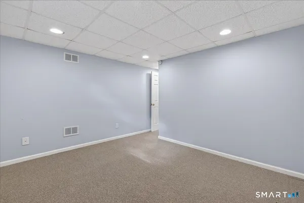 an empty room with staircase and window
