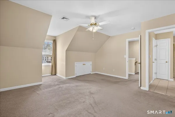 a view of an empty room with a ceiling fan