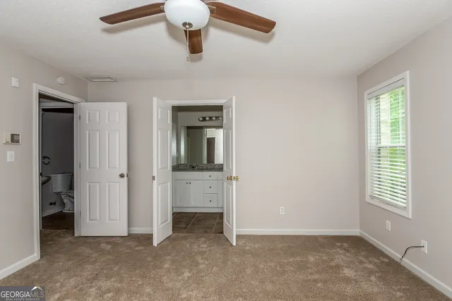 an empty room with windows and closet