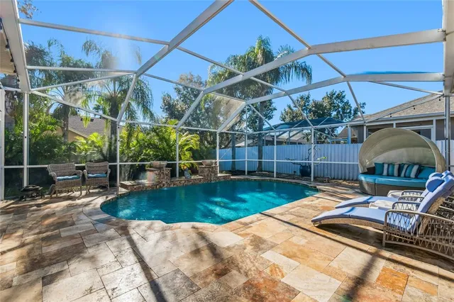 a kitchen with stainless steel appliances kitchen island granite countertop a refrigerator a stove a sink dishwasher and white cabinets with wooden floor