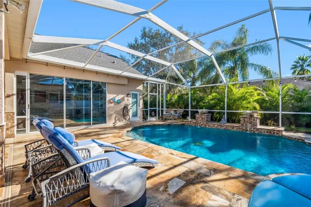 a kitchen with stainless steel appliances kitchen island granite countertop a table chairs and a refrigerator