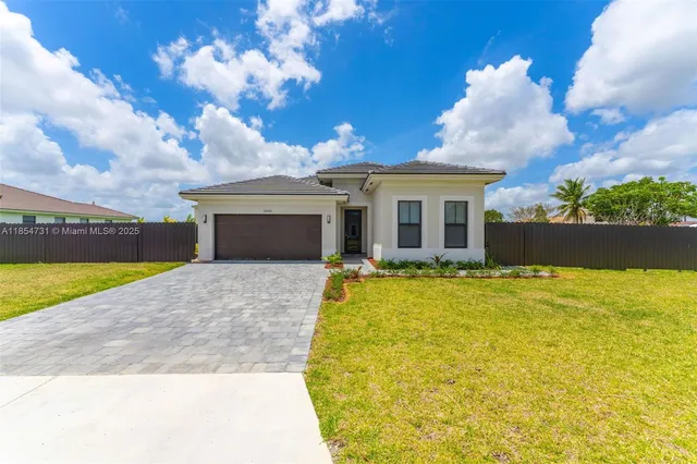 a view of a house with a backyard