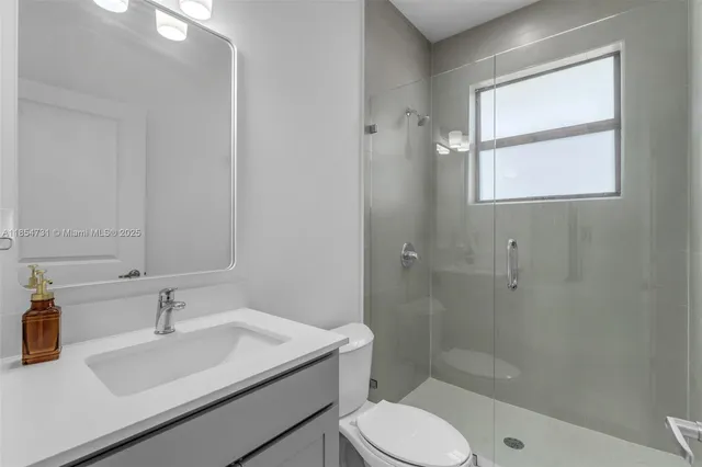 a bathroom with a sink toilet a vanity and shower
