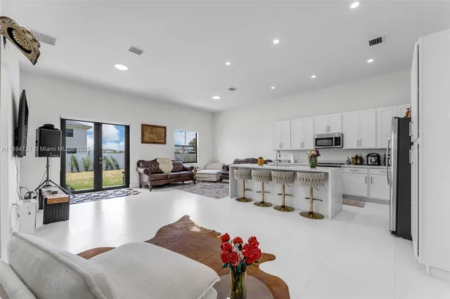 a living room with furniture and a large window