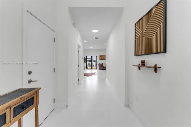 a view of hallway with livingroom and furniture