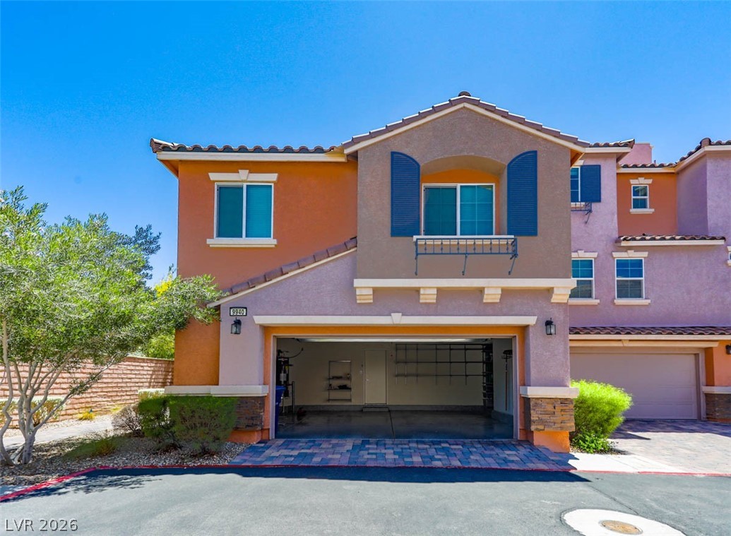 9940 Sable Point Street Las Vegas, NV 89178 - Photo 2 of 40 Mediterranean / spanish home featuring a tiled roof, an attached garage, stucco siding, and decorative driveway