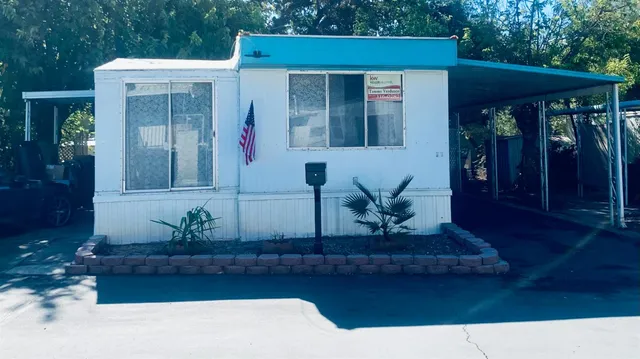 a view of a house with potted plants
