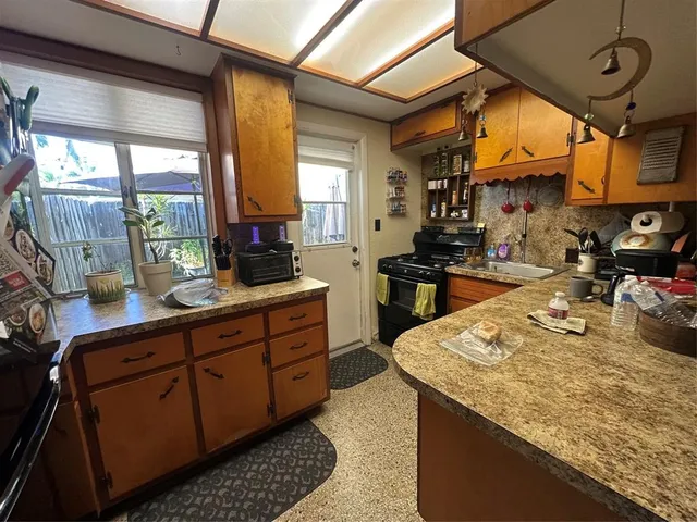 a kitchen with sink and cabinets