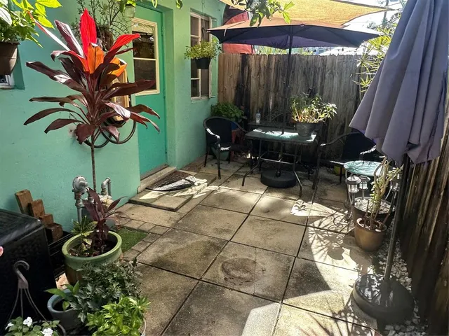 a backyard of a house with outdoor seating