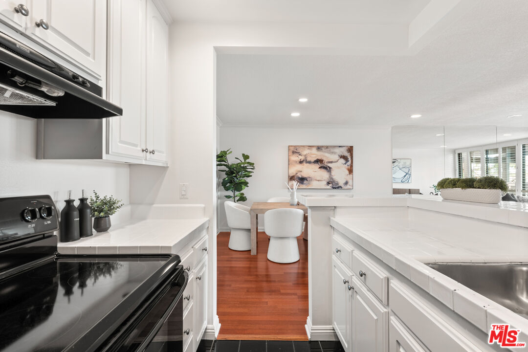 8640 Gulana Avenue, Unit K3017 Playa del Rey, CA 90293 - Photo 5 of 19 a kitchen with a stove and a white cabinets