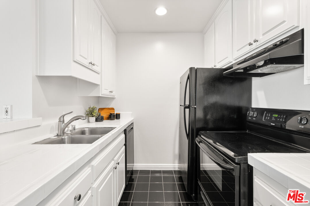 8640 Gulana Avenue, Unit K3017 Playa del Rey, CA 90293 - Photo 6 of 19 a kitchen with a sink and stainless steel appliances