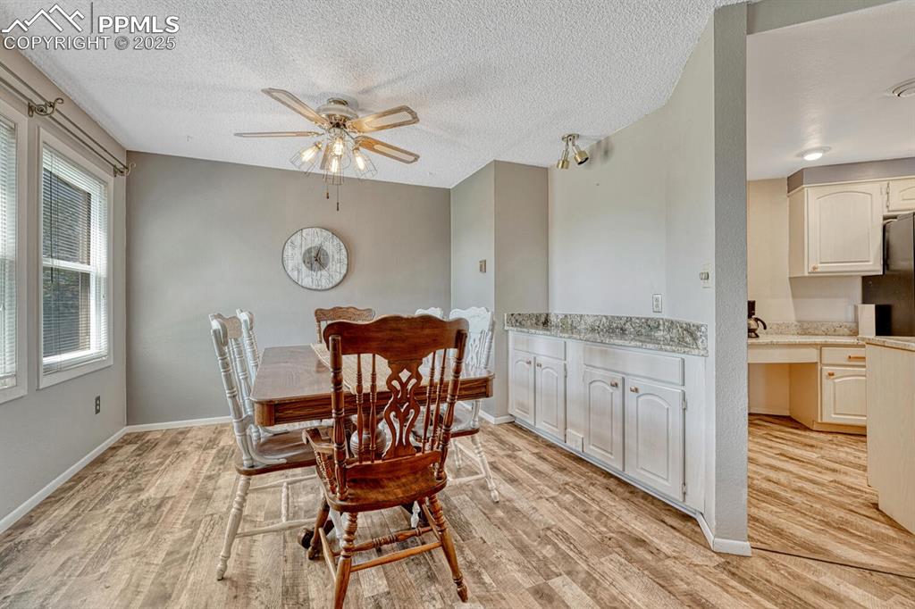 1661 Deer Creek Road Monument, CO 80132 - Photo 20 of 48 Dining room with built in buffet with granite countertop and views of the lake