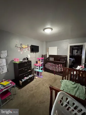 a bedroom with furniture and a flat screen tv