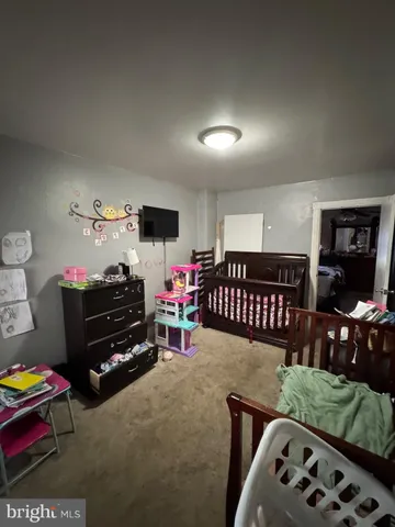 a bedroom with furniture and a flat screen tv