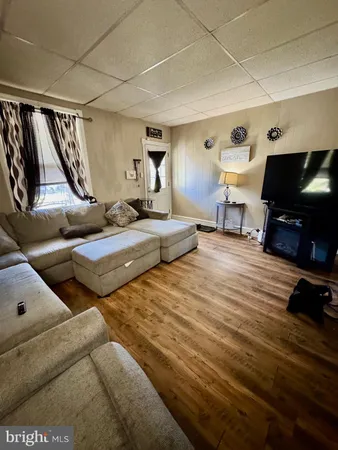 a bedroom with furniture and a flat screen tv