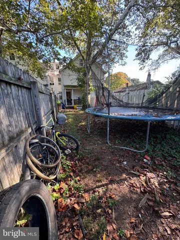 a backyard of a house with seating space and trees