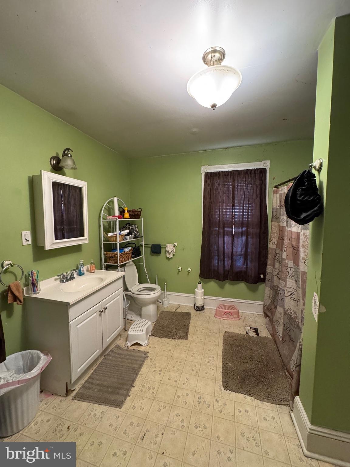 209 Willow Street Delanco, NJ 08075 - Photo 10 of 14 a living room with a couch and a chandelier