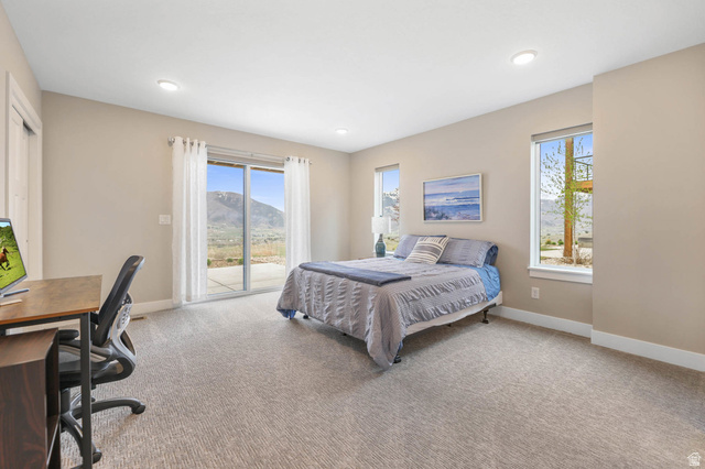 4527 North Seven Bridges Road Eden, UT 84310 - Photo 37 of 65 Bedroom with a desk, access to exterior, light colored carpet, a mountain view, and recessed lighting
