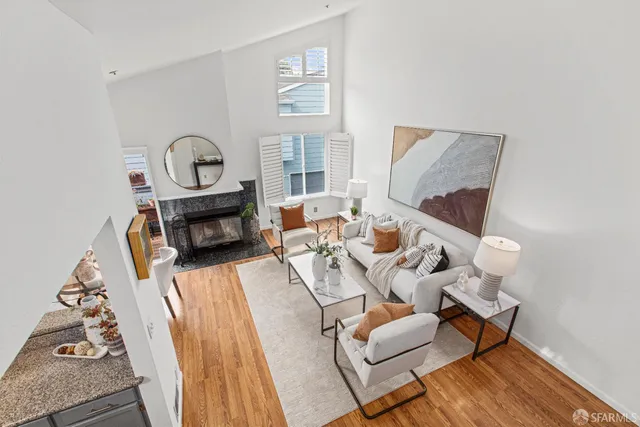 a living room with furniture a fireplace and a window