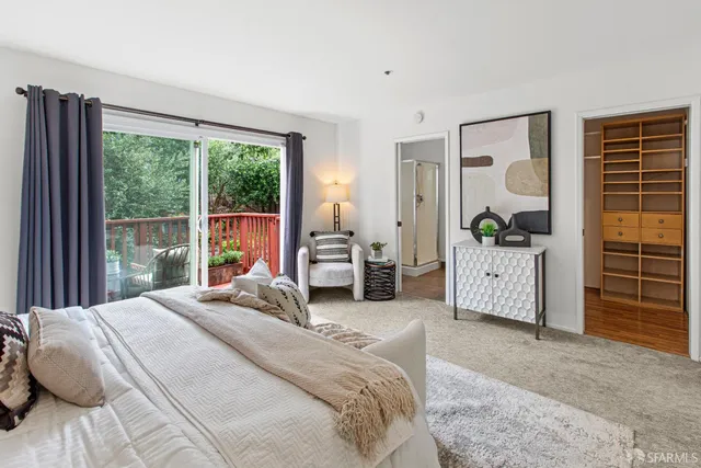 a bedroom with bed and walk in closet